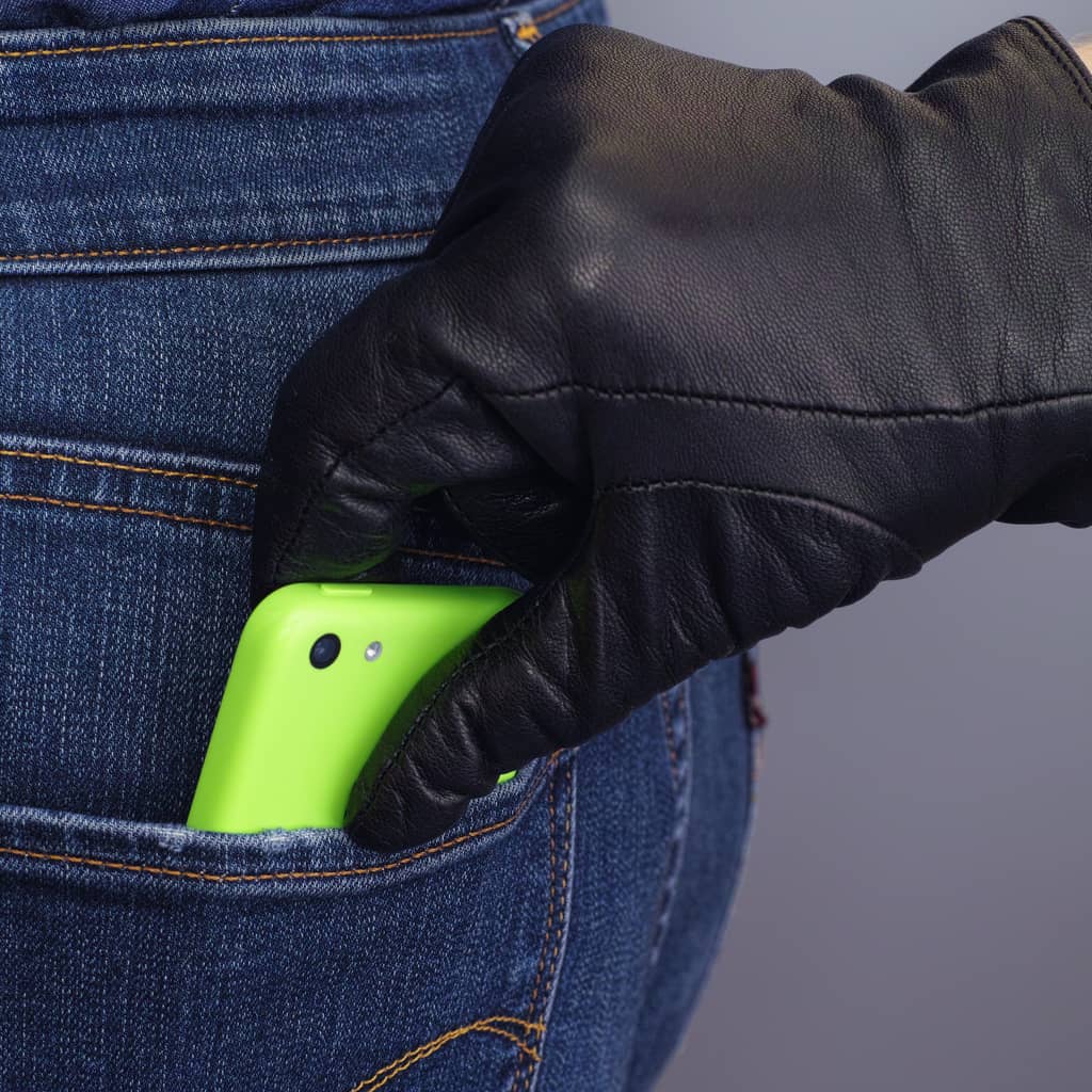 Un voleur dérobe un téléphone dans la poche d'une personne